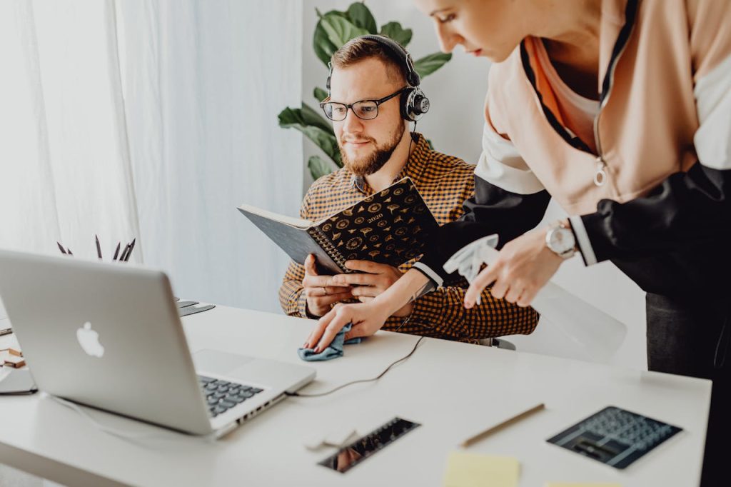 A man and woman working together at a desk, enhancing productivity.